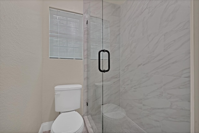 full bath with a stall shower, toilet, and a textured wall