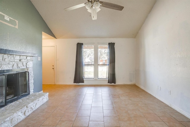 unfurnished living room featuring lofted ceiling, a stone fireplace, light tile patterned floors, baseboards, and ceiling fan