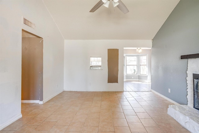 unfurnished living room with light tile patterned floors, baseboards, visible vents, a fireplace, and ceiling fan