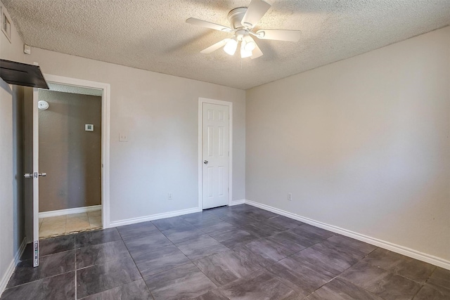 unfurnished room with baseboards, a textured ceiling, and a ceiling fan