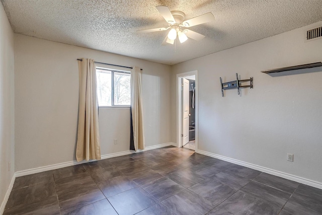 unfurnished room featuring visible vents, baseboards, a textured ceiling, and ceiling fan