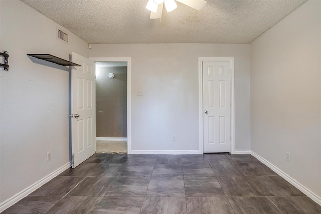 unfurnished bedroom featuring visible vents, baseboards, a textured ceiling, and a ceiling fan