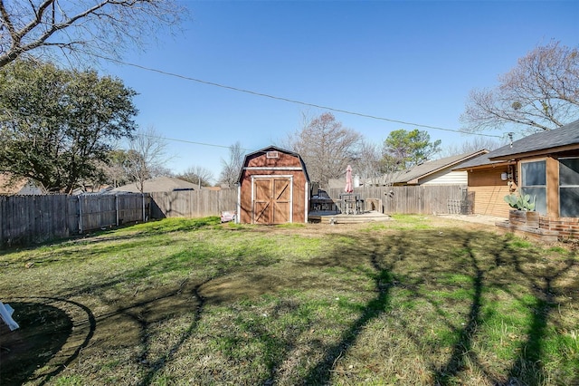 view of yard featuring a storage shed, an outbuilding, and a fenced backyard