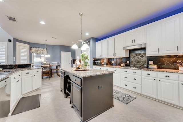 kitchen with white cabinets, visible vents, under cabinet range hood, and stainless steel appliances