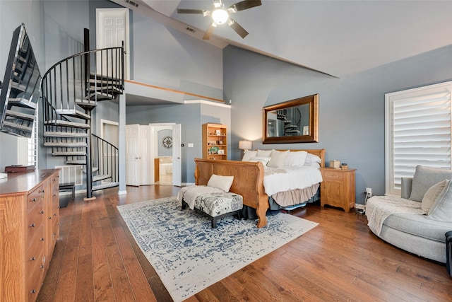 bedroom with dark wood-type flooring, visible vents, baseboards, and high vaulted ceiling