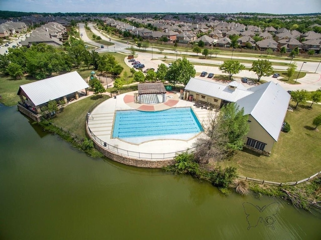 drone / aerial view featuring a residential view and a water view