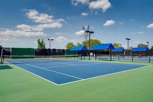 view of tennis court featuring fence