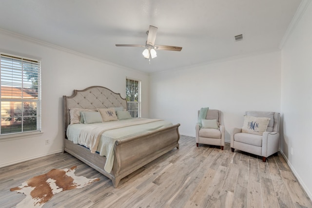 bedroom featuring visible vents, crown molding, and light wood-type flooring