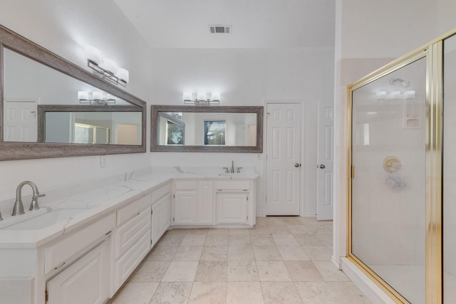 full bath with a sink, double vanity, visible vents, and a stall shower