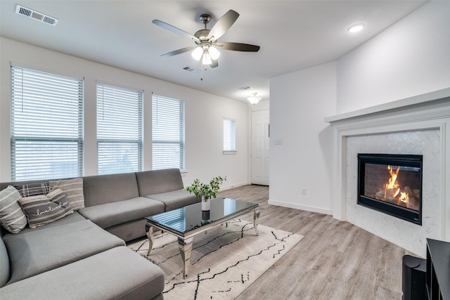 2765 Pease Dr, Forney, TX 75126 - living area with ceiling fan, visible vents, a high end fireplace, wood finished floors, and baseboards