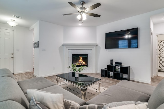2765 Pease Dr, Forney, TX 75126 - living room featuring ceiling fan, arched walkways, light wood finished floors, recessed lighting, and a premium fireplace