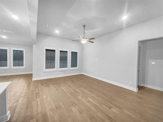 unfurnished living room with visible vents, a ceiling fan, wood finished floors, recessed lighting, and baseboards