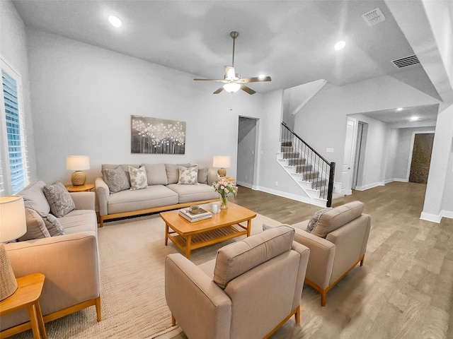 living area with visible vents, wood finished floors, recessed lighting, baseboards, and stairs