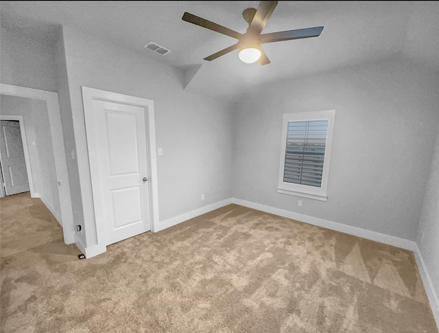 empty room featuring baseboards, visible vents, carpet floors, and ceiling fan