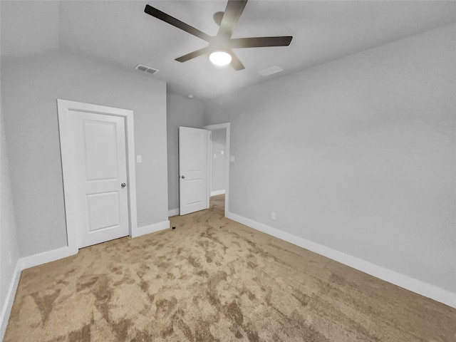 unfurnished bedroom with ceiling fan, carpet, visible vents, and baseboards