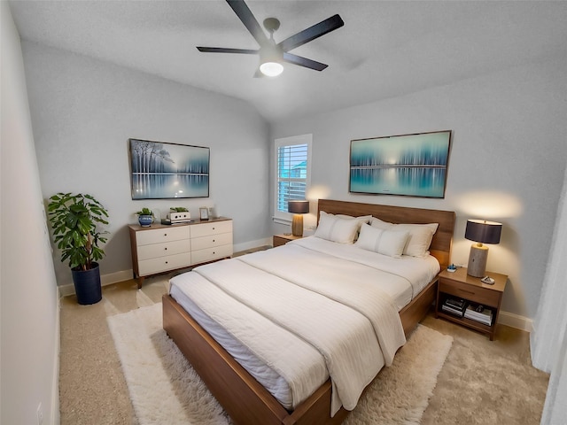 bedroom with light carpet, baseboards, lofted ceiling, and a ceiling fan