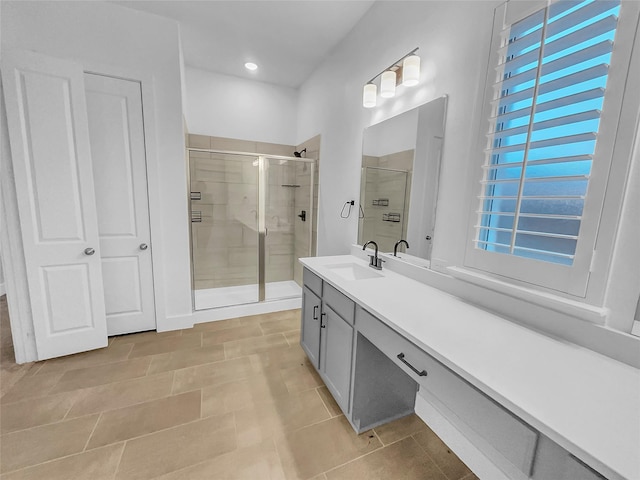 bathroom featuring a stall shower and vanity