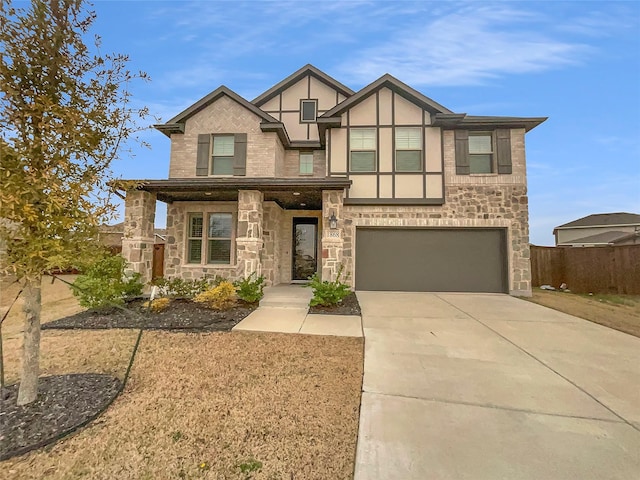 view of front facade featuring fence, stucco siding, a garage, stone siding, and driveway