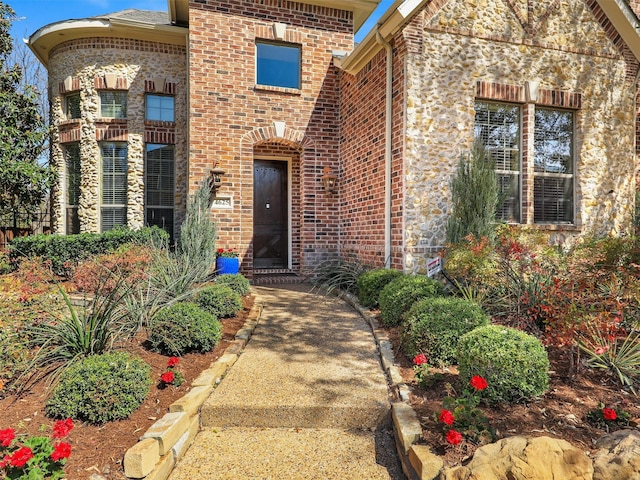 doorway to property with brick siding