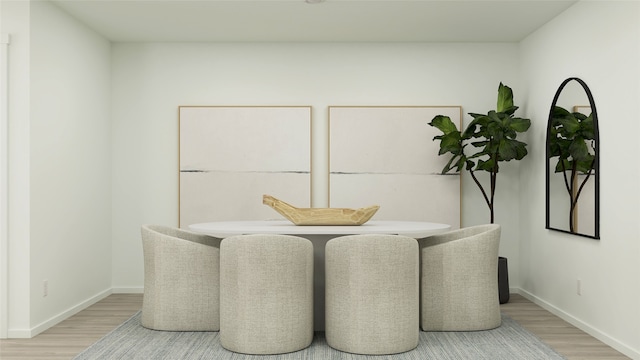 dining area featuring baseboards and light wood-style flooring