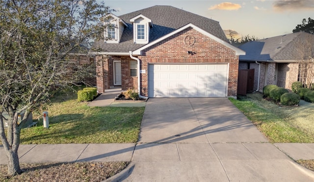 4011 Ridgetop Dr, Heartland, TX 75126 - view of front of house with a front lawn, driveway, roof with shingles, a garage, and brick siding