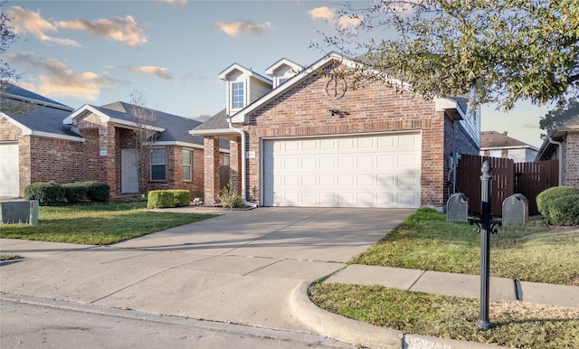 4011 Ridgetop Dr, Heartland, TX 75126 - view of front of home with fence, an attached garage, concrete driveway, a front lawn, and brick siding