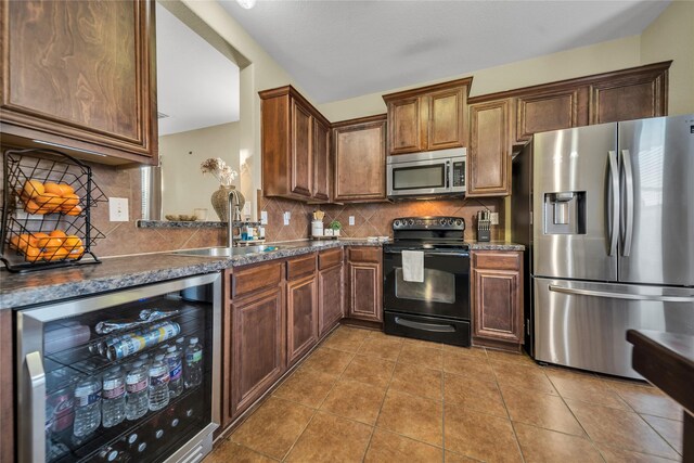 4011 Ridgetop Dr, Heartland, TX 75126 - kitchen with beverage cooler, a sink, dark countertops, stainless steel appliances, and tile patterned flooring