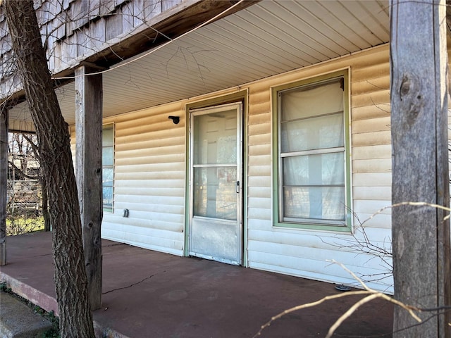 doorway to property with log veneer siding