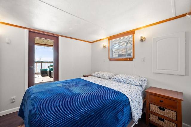 bedroom with baseboards and wood finished floors