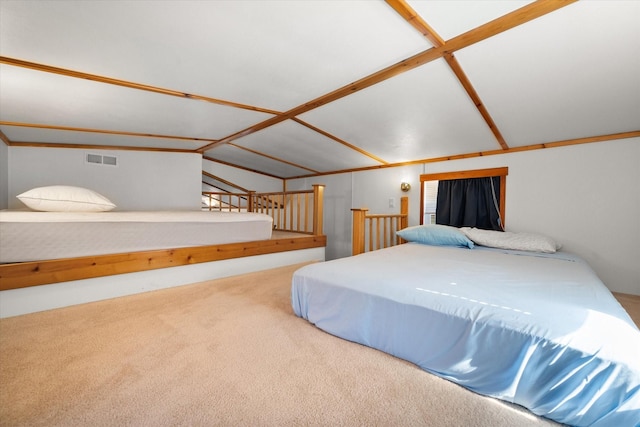 carpeted bedroom with visible vents and vaulted ceiling