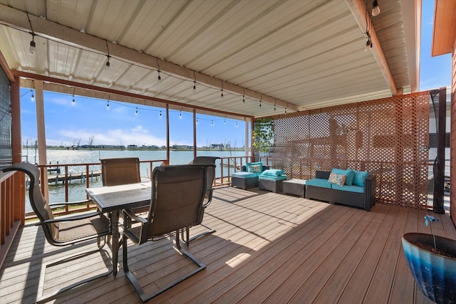 wooden deck with a water view and an outdoor hangout area