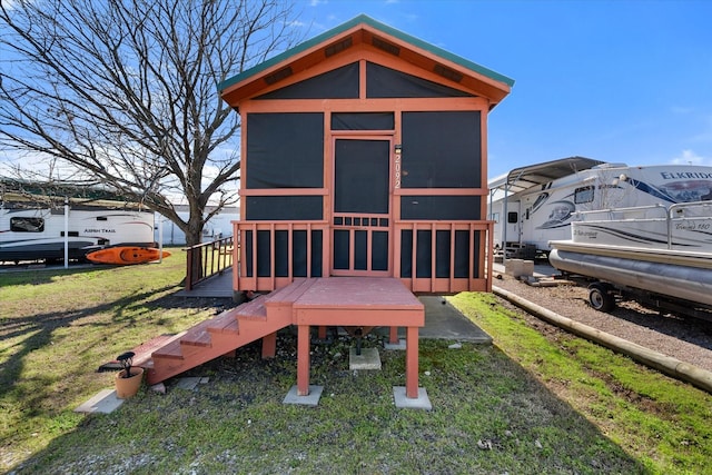 view of outbuilding featuring a sunroom