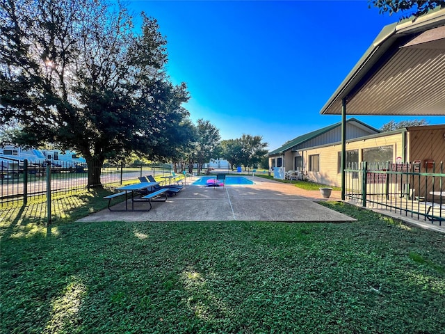 view of yard with a patio area, a fenced in pool, and fence