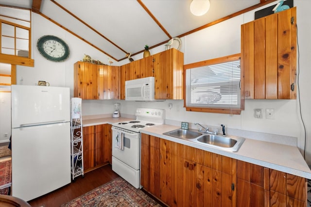 kitchen featuring white appliances, light countertops, brown cabinets, and a sink