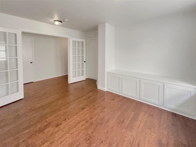 unfurnished room with french doors and light wood-style floors