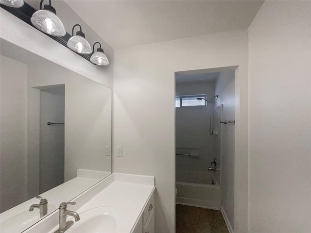 full bathroom with baseboards,  shower combination, and vanity