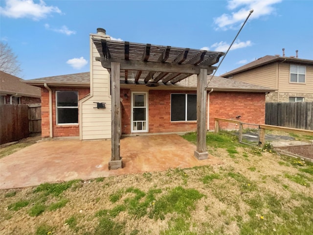 back of property featuring brick siding, a chimney, a fenced backyard, a pergola, and a patio