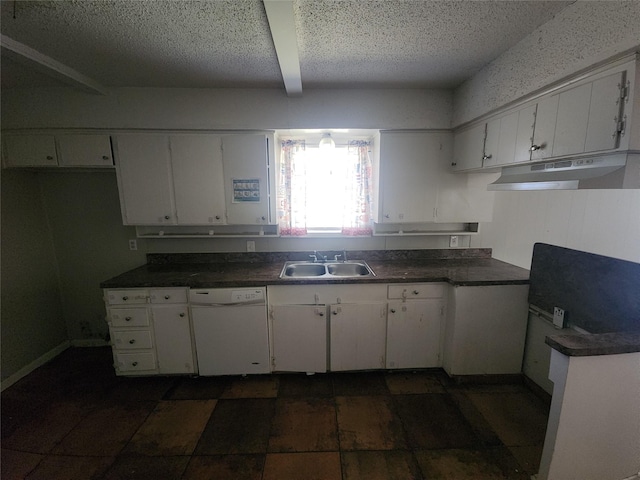 kitchen with dark countertops, under cabinet range hood, white dishwasher, white cabinets, and a sink