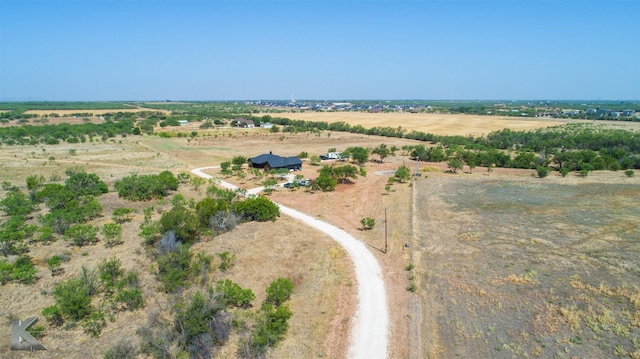 birds eye view of property with a rural view