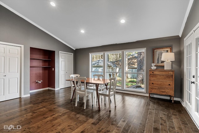 dining space with lofted ceiling, dark wood-style floors, baseboards, and ornamental molding