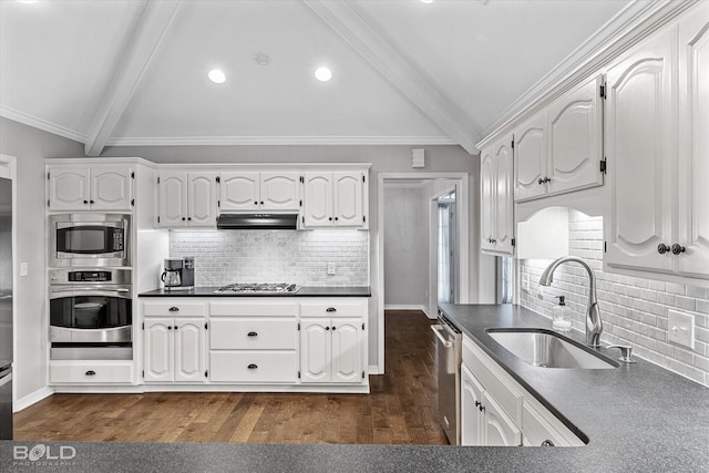 kitchen featuring vaulted ceiling with beams, under cabinet range hood, appliances with stainless steel finishes, white cabinetry, and a sink