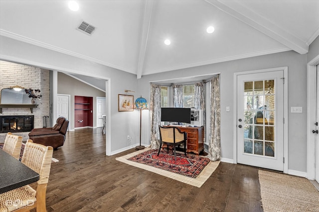 living area with visible vents, vaulted ceiling with beams, baseboards, a fireplace, and wood finished floors