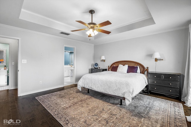 bedroom featuring baseboards, a raised ceiling, wood-type flooring, and ornamental molding