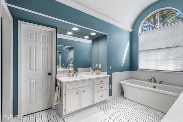 bathroom featuring recessed lighting, a soaking tub, a healthy amount of sunlight, and vanity