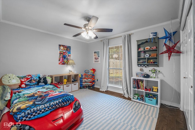 bedroom with a closet, wood finished floors, baseboards, and ornamental molding