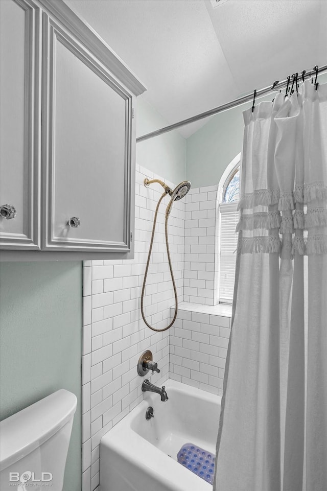 bathroom with toilet and shower / tub combo