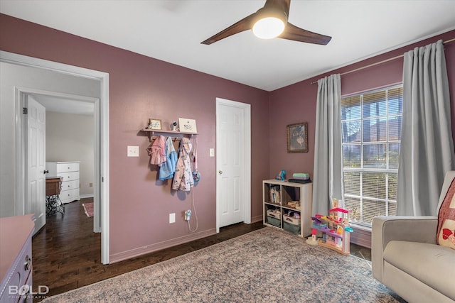 game room with baseboards, wood finished floors, and ceiling fan