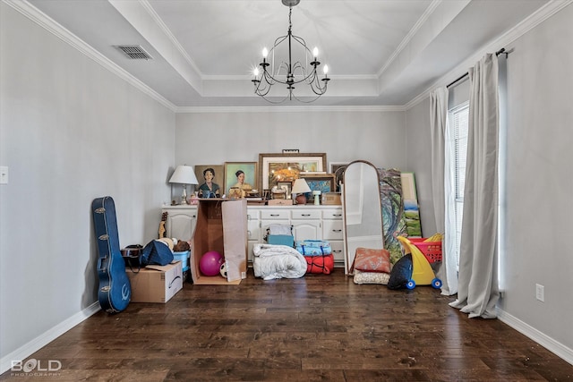 dining area featuring baseboards, visible vents, hardwood / wood-style flooring, a raised ceiling, and a chandelier