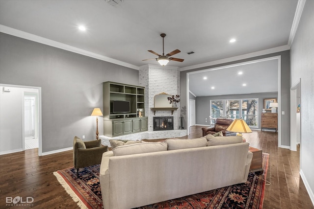 living area featuring baseboards, dark wood-style flooring, a fireplace, and crown molding