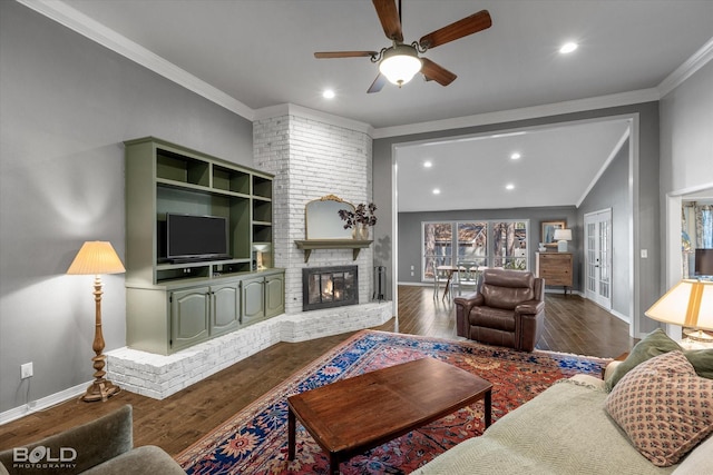 living room featuring a brick fireplace, dark wood-style floors, vaulted ceiling, and ornamental molding